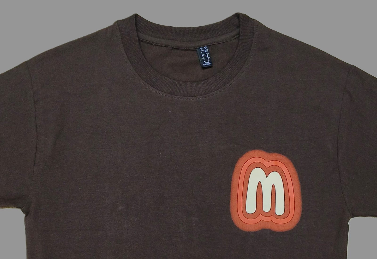 Men’s Brown Graphic T-Shirt with Retro “M” Logo – Casual Streetwear Tee