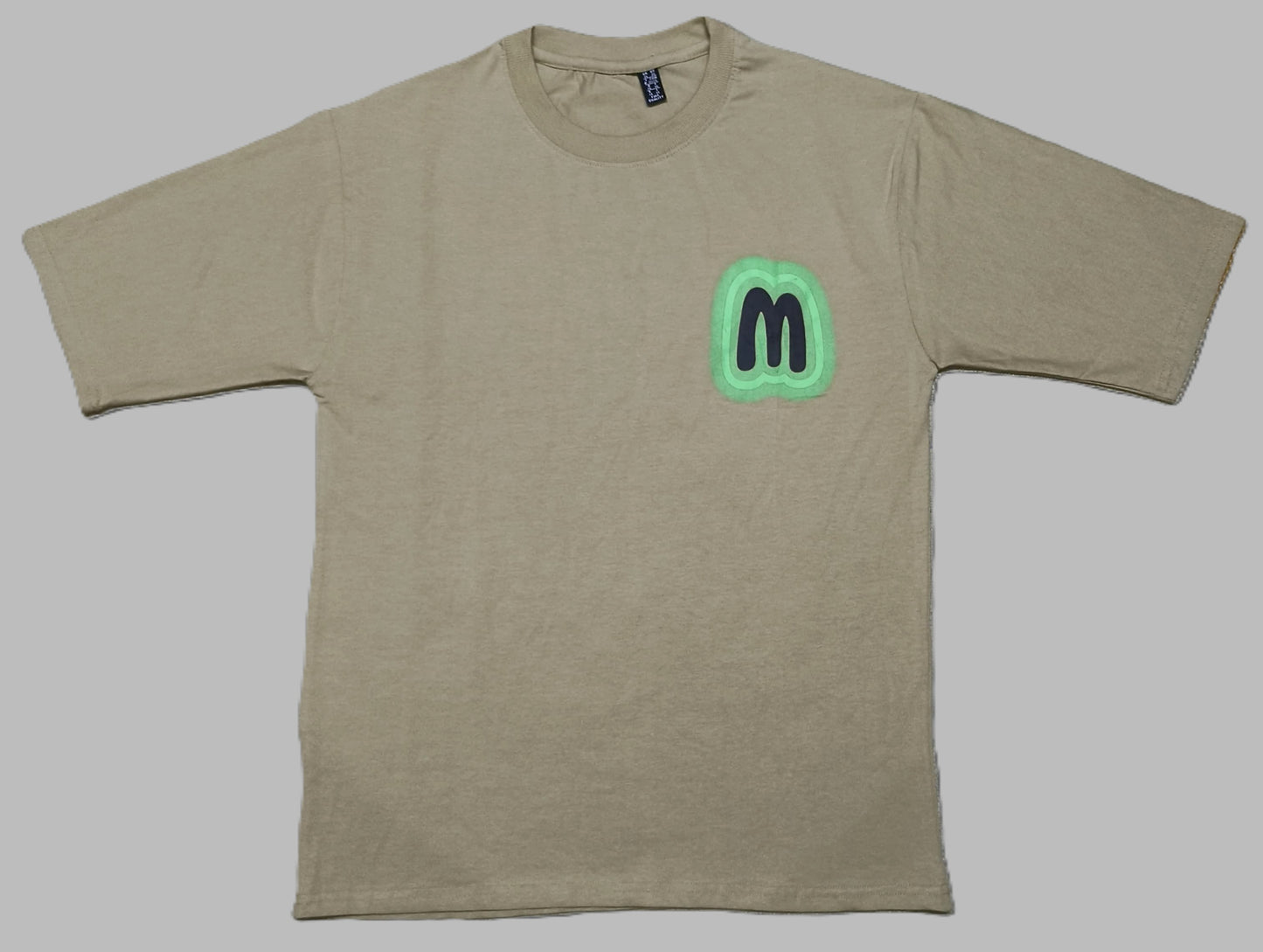 Men’s Beige Graphic T-Shirt with Neon Green “M” Logo – Urban Casual Streetwear