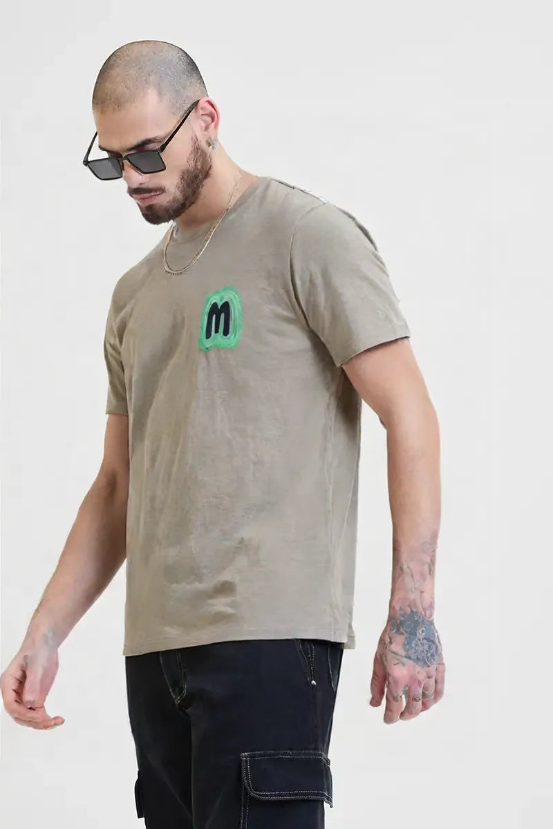 Men’s Beige Graphic T-Shirt with Neon Green “M” Logo – Urban Casual Streetwear
